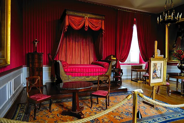 A red-draped bedchamber in the royal residence of the Château d'Amboise